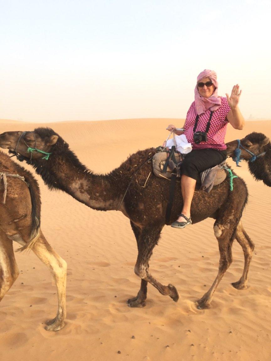 {Jane Cooley rides a camel in Morocco.}